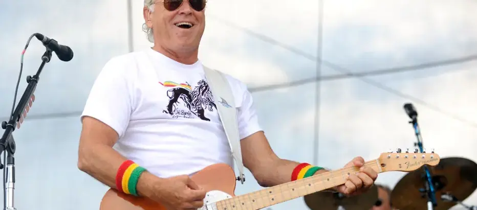 Jimmy Buffett's smile is a melody of a thousand songs, a sunlit invitation to paradise