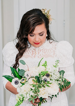 Bride holding lush custom bouquet during wedding day, planned with full-service coordination.