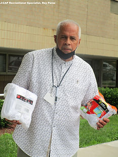 5. Hanes Sock Drive 2021 - J-CAP Recreational Specialist Ray Perez with socks and masks.JP