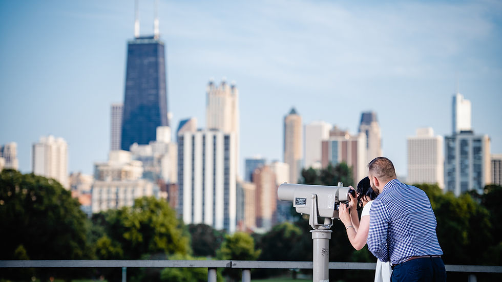 Wide-angle view of a couple at Lincoln Park Honeycomb with Chicago skyline behind them
