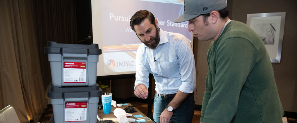 Candid photo of coworkers networking at corporate event.