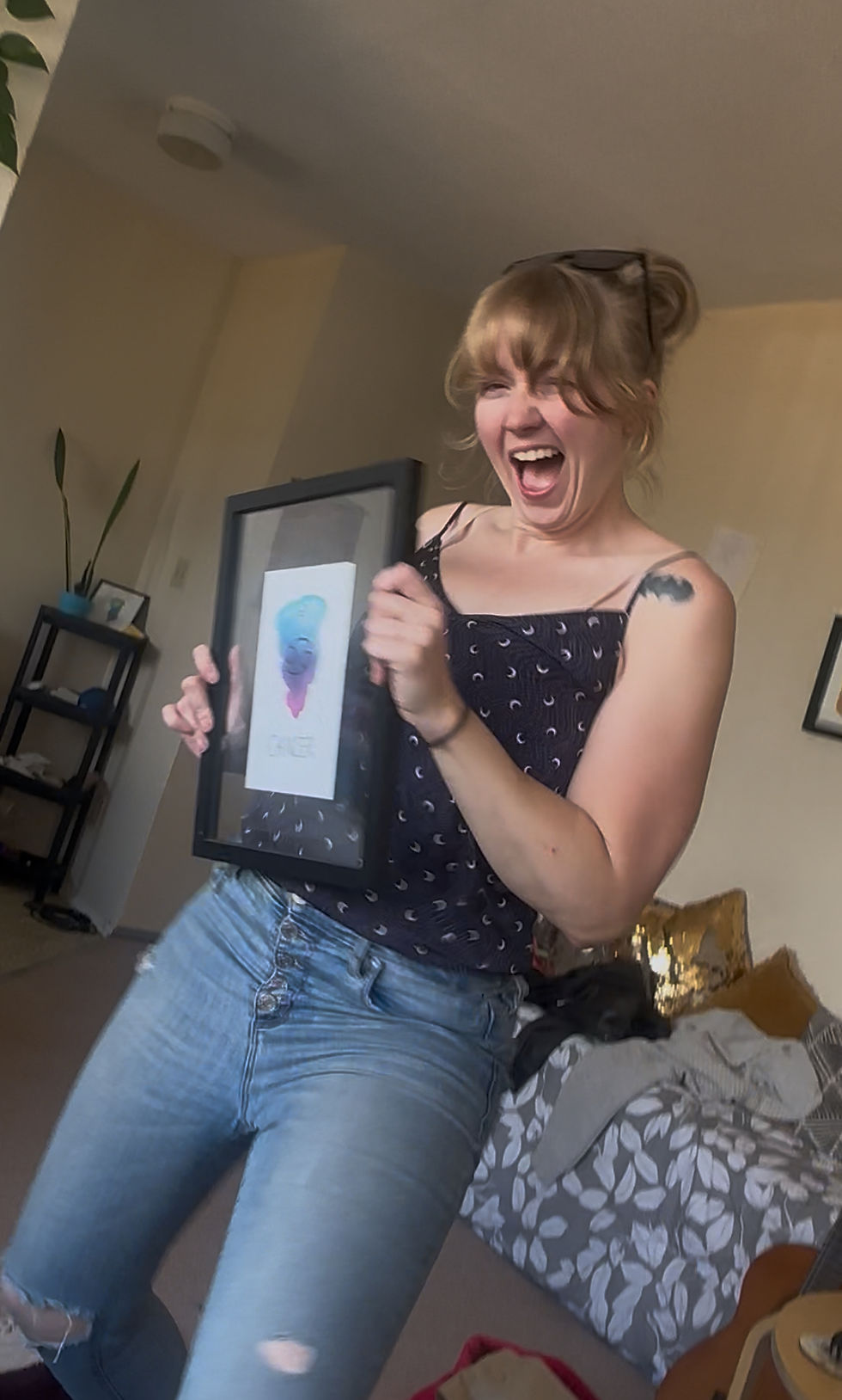 Photo of Taylor holding her zodiac sign Cancer art print