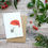 Thumbnail: Illustrated sulphur cockatoo wearing santa hat Christmas card made from recycled paper and eco friendly plastic-free wrapper