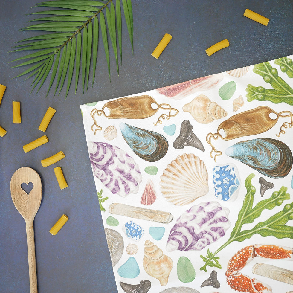 Thumbnail: A beachcombing themed tea towel with illustrated shells and other beach finds on a white background