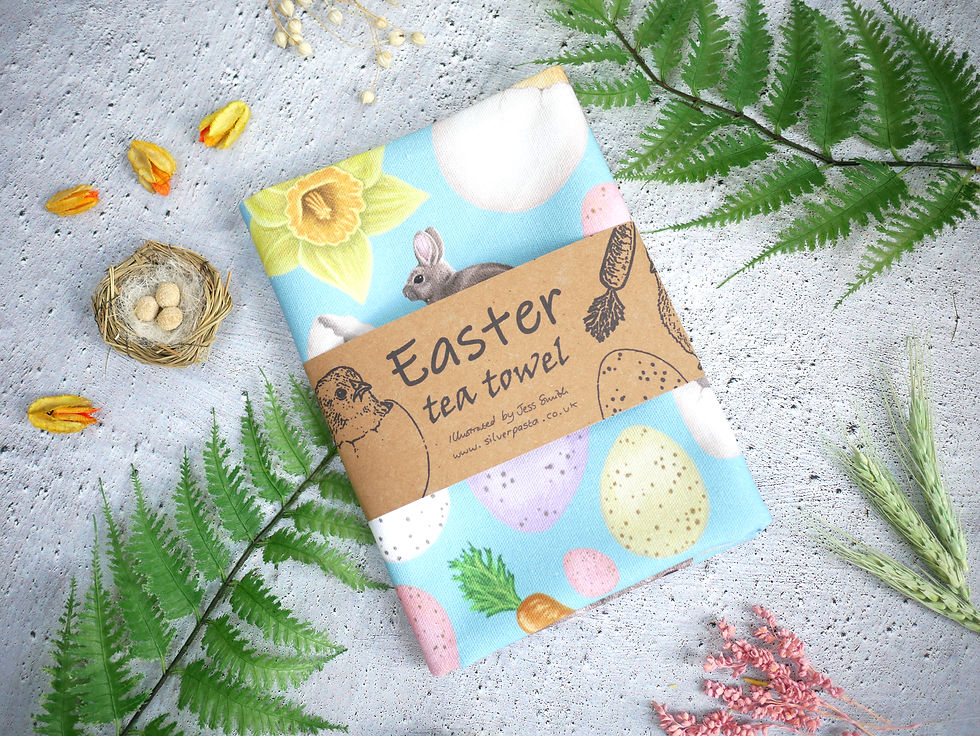 Thumbnail: A packaged Easter tea towel with kraft brown packaging that reads Easter tea towel illustrated by jess smith
