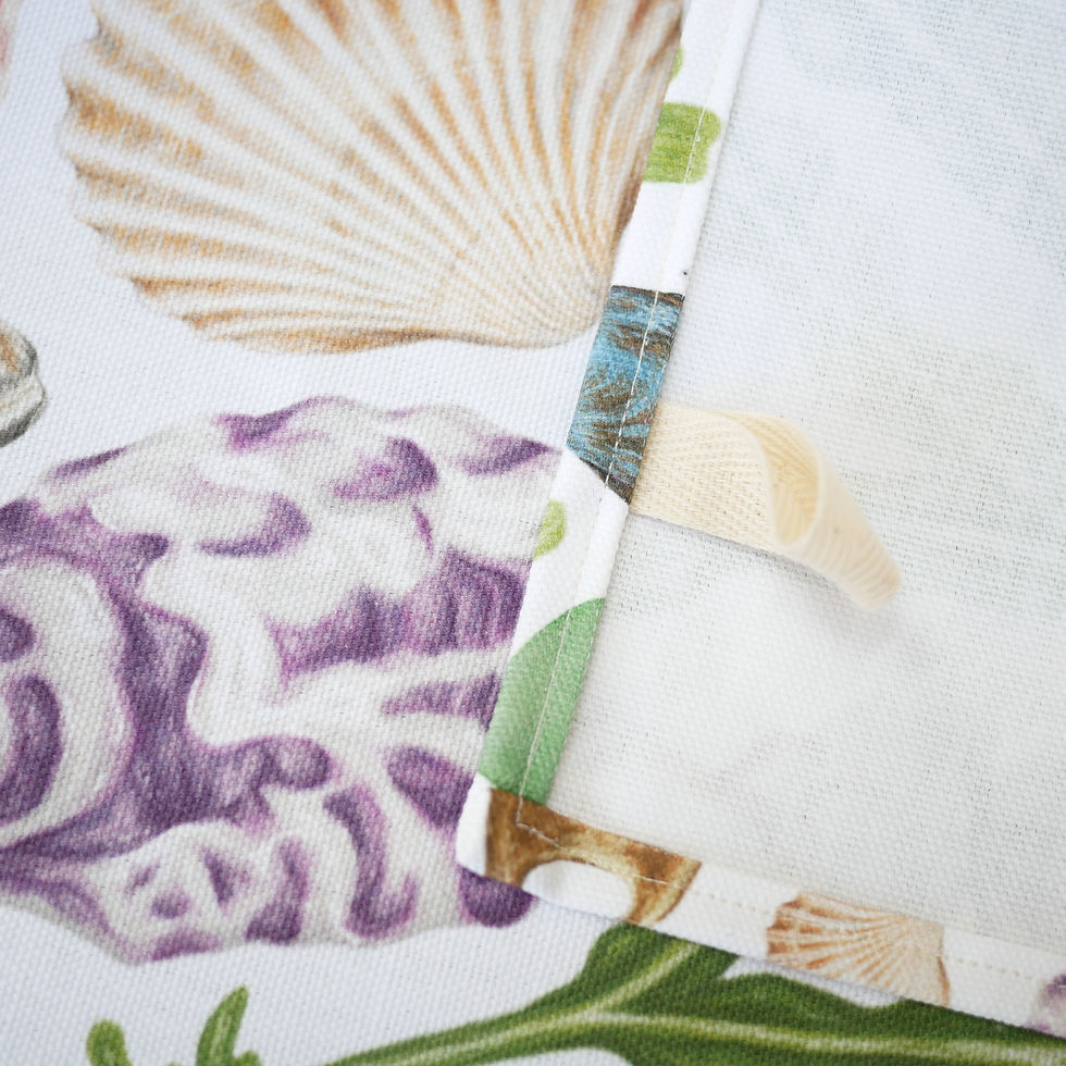 Thumbnail: A hanging label on a beachcombing themed tea towel