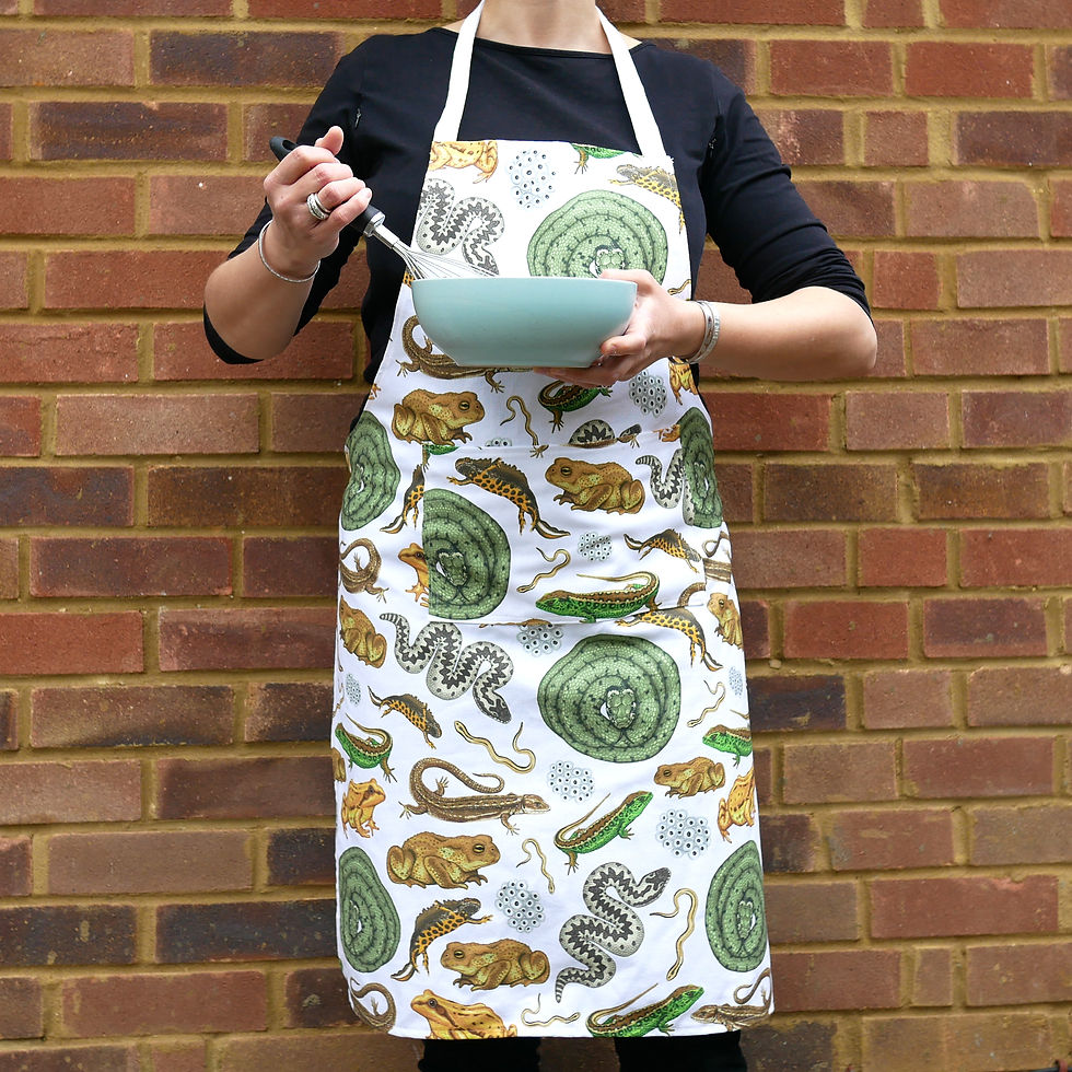 Thumbnail: An organic cotton apron with illustrated reptiles and amphibians including frog, toad, grass snake, adder, lizards