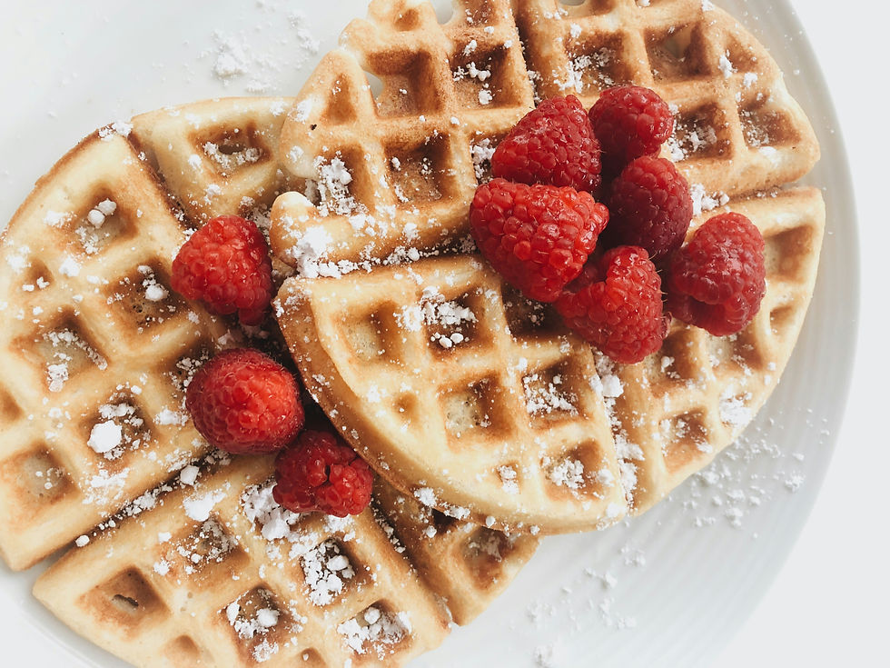 Waffles with powdered sugar and raspberries