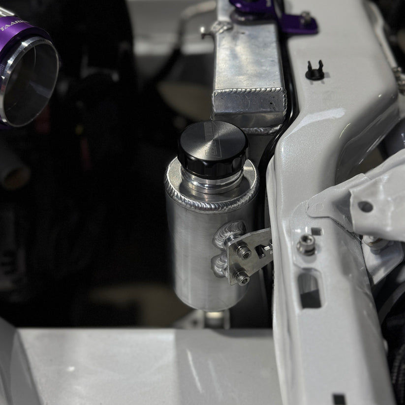 Nissan Silvia s13/180sx engine bay with Lazaro Motorsports overflow bottle mounted in raw aluminium