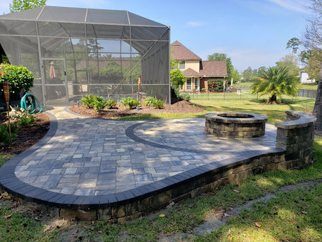 Backyard patio featuring custom pavers and a cozy fire pit, perfect for outdoor gatherings and relaxation.