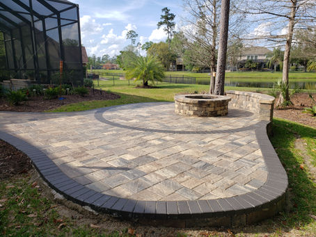 Pavers with a fire pit in the outdoor area of a backyard