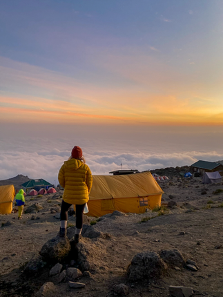 A photo of my looking out over the clouds at sunset from camp
