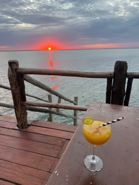 A passionfruit martini and sunset