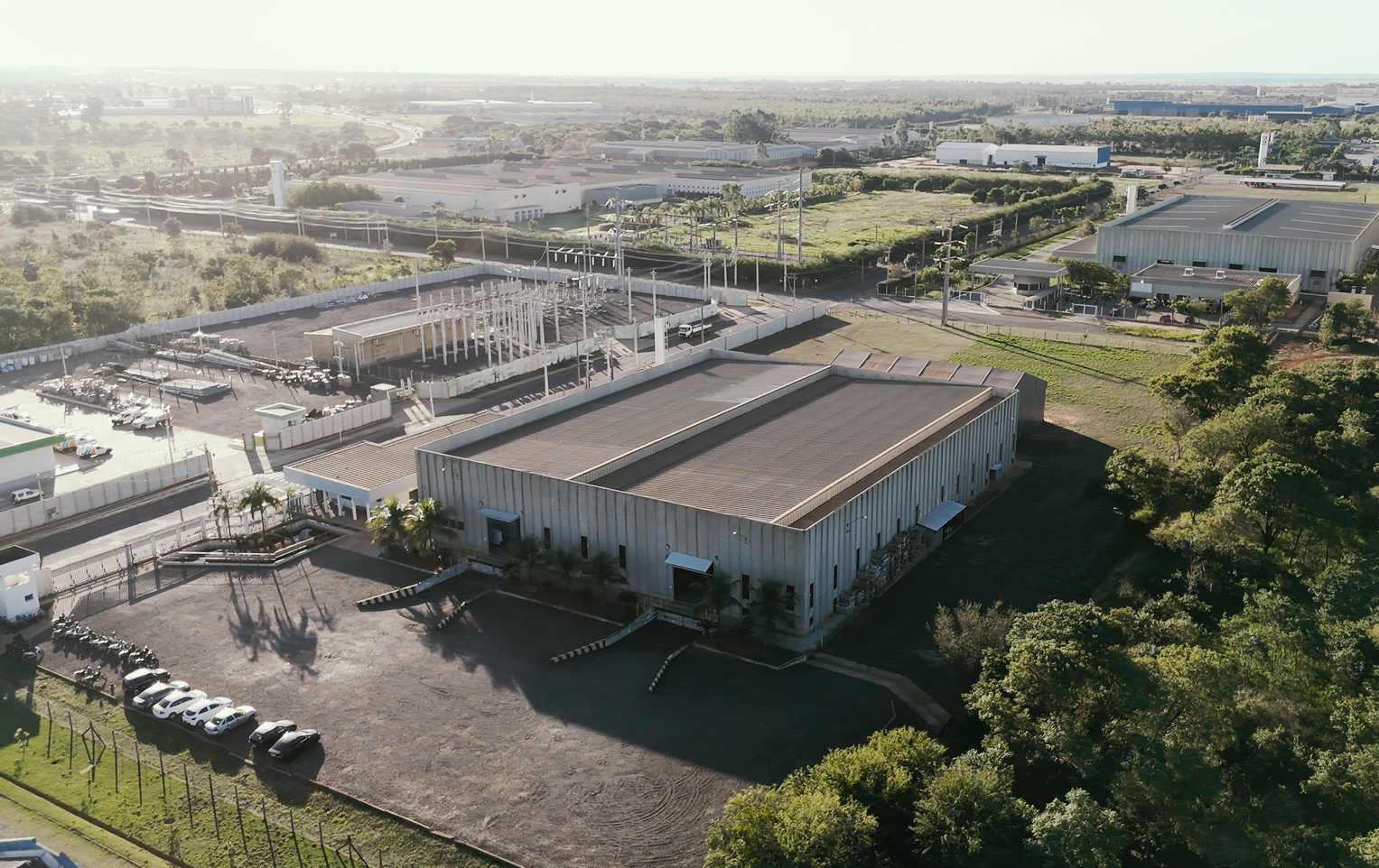Imagen aérea de un complejo industrial con grandes naves y zonas de circulación en una zona urbana.