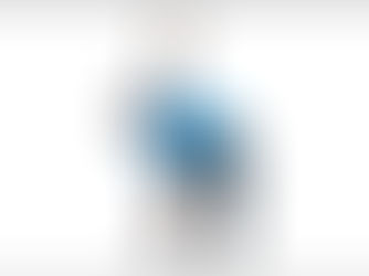 Man in blue shirt doing a stretch with a kettlebell overhead, bending over in a white studio. He appears focused and balanced.