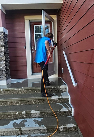 Man soft washing glass door