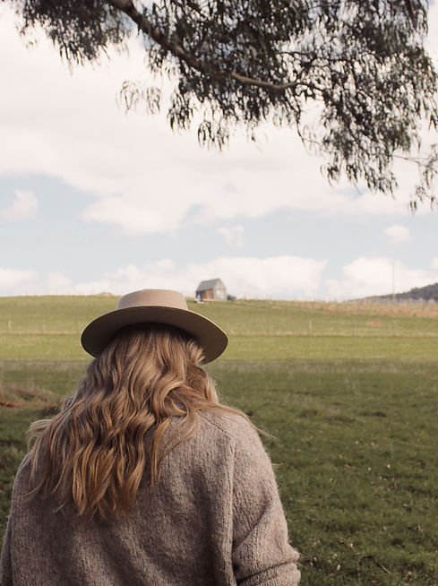 Sharni Ames from Sharni Ames Coaching walking in the Yarra Ranges near a tiny home