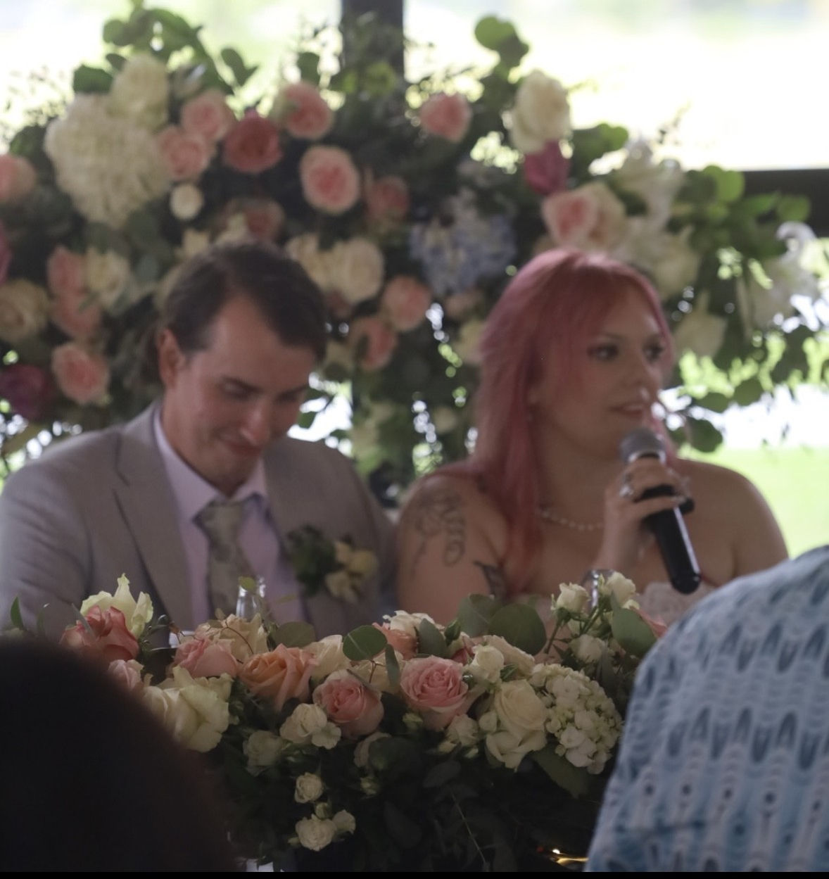 Shirley and Brent laughting at sweetheart table