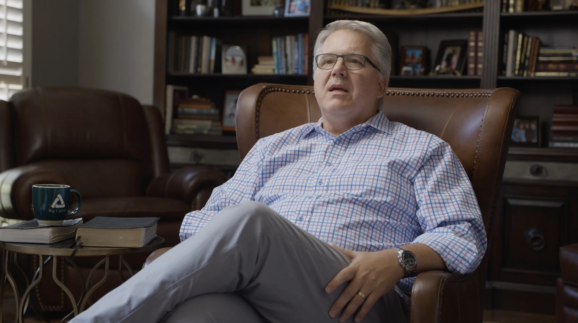 Pete Loescher seated in his study in the Ripples film