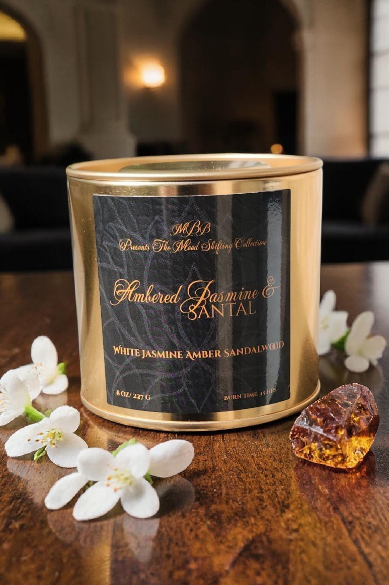 Ambered Jasmine &amp; Santal candle with a golden amber glow.