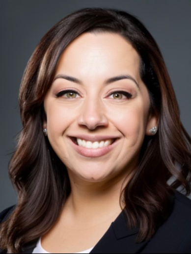 Smiling woman in business attire, professional headshot on a gray background.