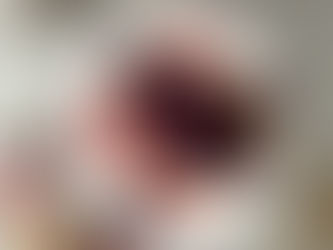 A vibrant Valentine’s Day dish of roasted purple sweet potatoes on a bed of creamy pickled beet hummus, topped with melted butter and sliced marinated chilies, plated elegantly for an intimate dinner or special occasion.