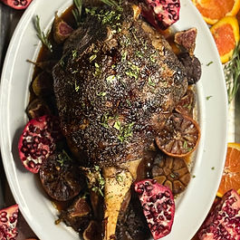This succulent roasted leg of lamb is slow-cooked with plums, vibrant citrus, garlic, and red wine, creating a rich, savory-sweet sauce. Garnished with fresh rosemary and pomegranate, it’s a stunning centerpiece for holiday or special occasion meals.