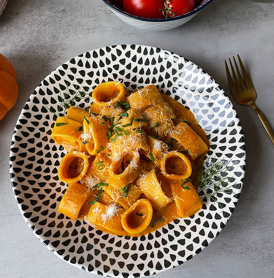 Bowl of pumpkin pasta with sage and parmesan.