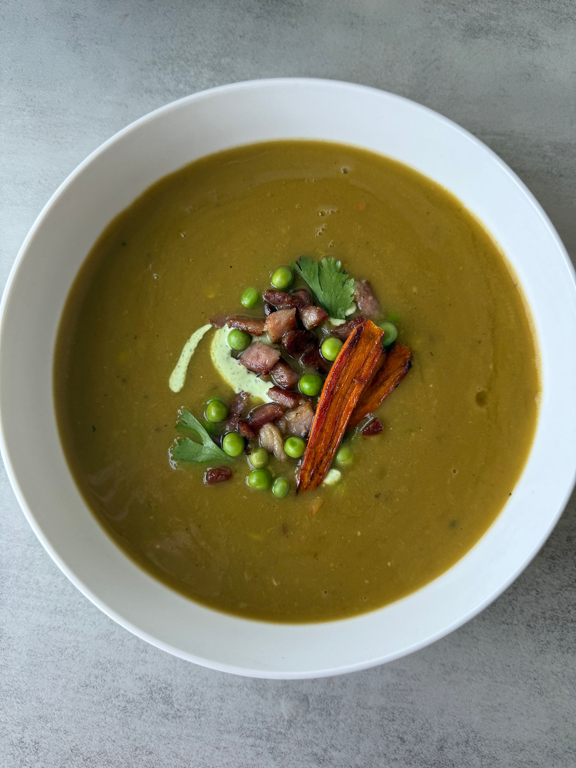 Split Pea Soup with crispy ham, fresh peas, roasted carrots, and herby mint yogurt dressing