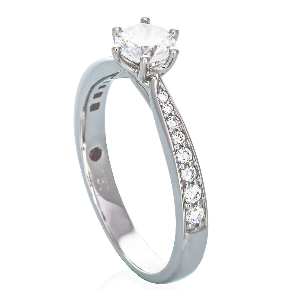 Jewellery product photo of a diamond engagement ring with polished band on white background.