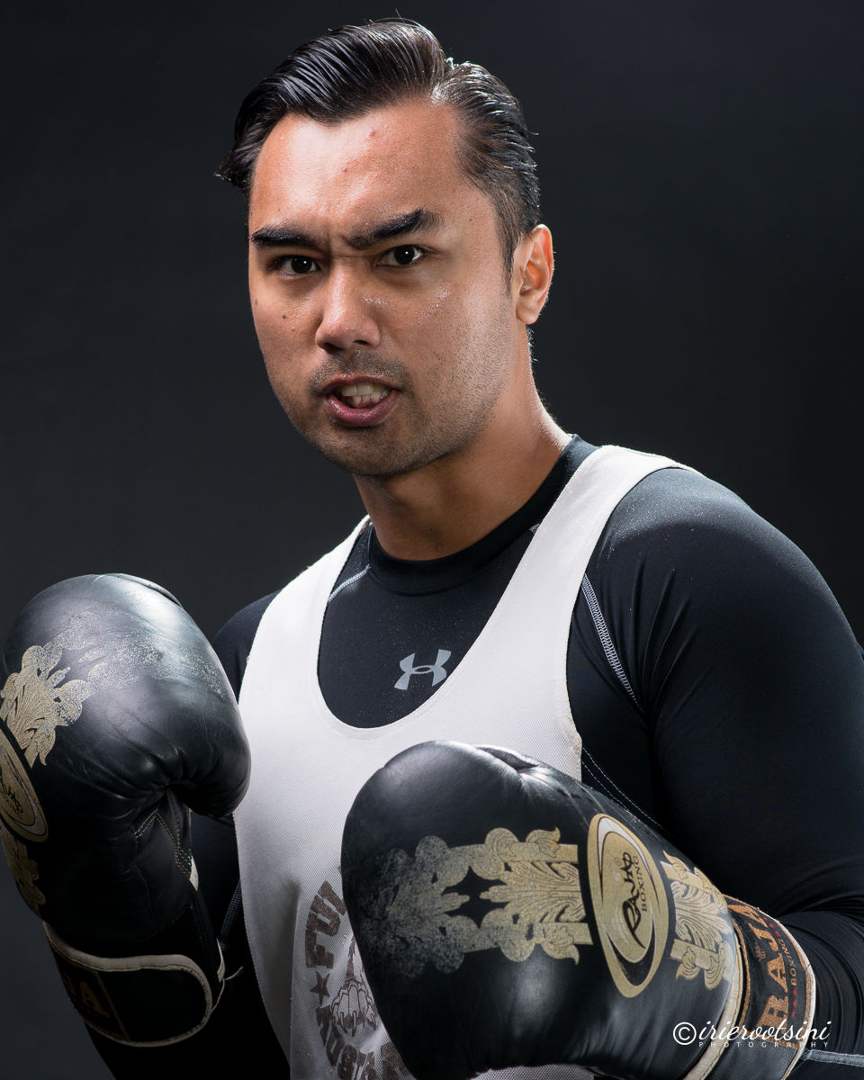 Intense boxing headshot pose, actor in gloves with strong expression