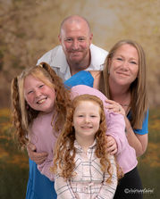 Family of four during a Creative Studio Portrait Session with the Summer Orchard themed backdrop.
