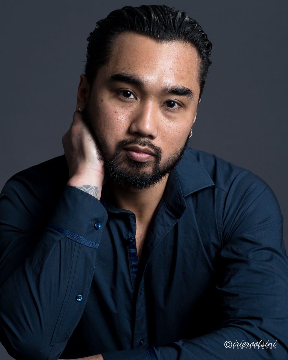 Relaxed actor headshot pose with hand resting against face