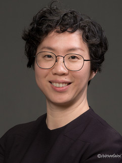 Studio corporate headshot of business professional with grey background