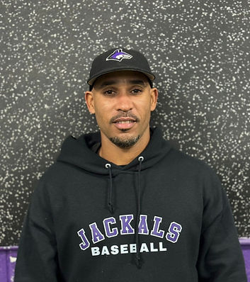 An image of Coach Ian standing against a grey wall