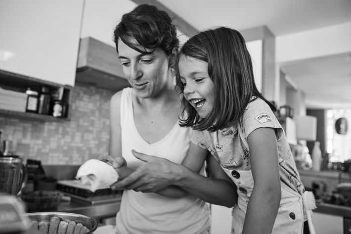 Mom & daughter laughing cooking together