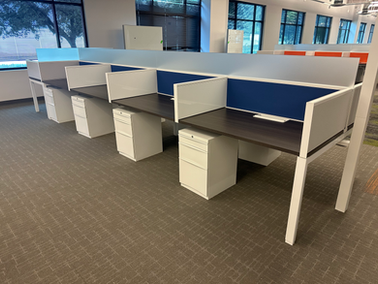 workstations and cubicles in an office with other office furniture
