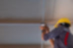 A man repairing in an industiral site a led