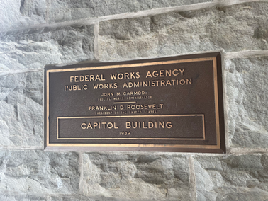 Plaque that reads: Federal Works Agency/Public Works Administration/John Carmody/Franklin Roosevelt/Capitol Building 1939