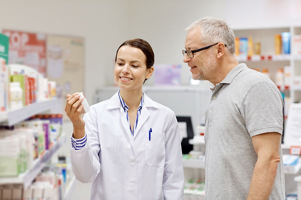 Pharmacist showing patient a medication
