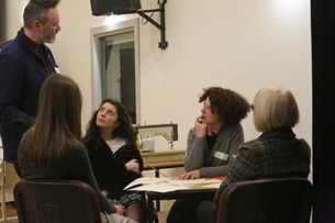 Adults around table sharing ideas 