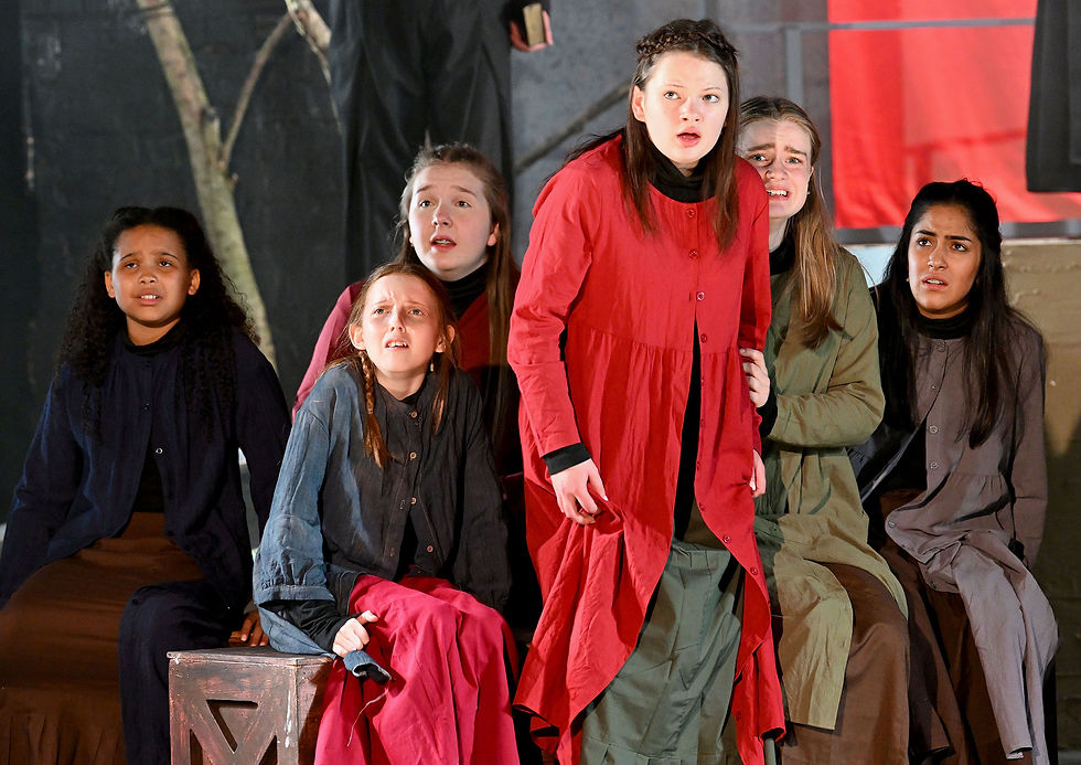 Abigail (Alice Guard) standing and fellow cast members. Photo credit Martin Pulley.