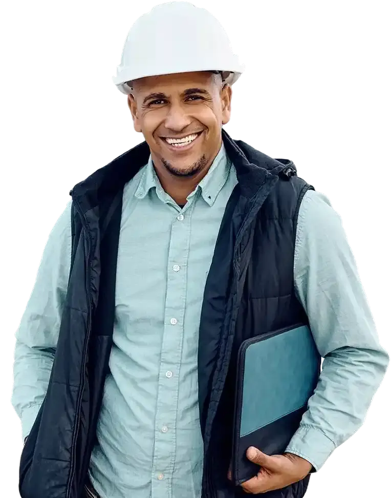 Smiling engineer with a white hard hat and laptop, construction background.