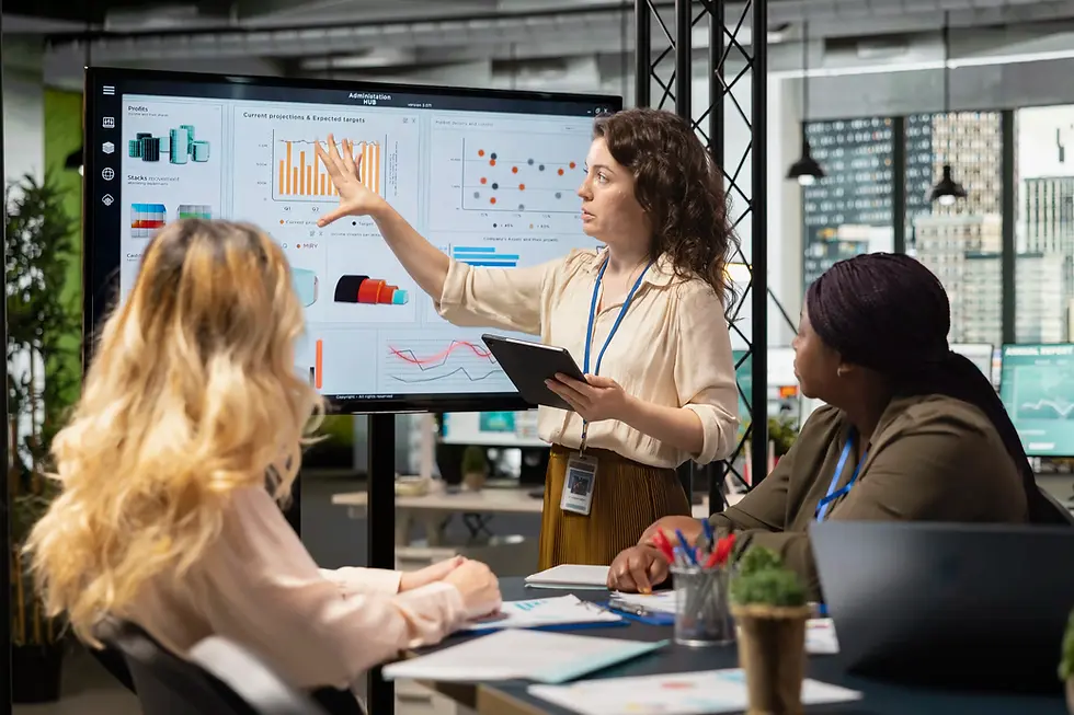 Professional presenting data on a large screen to a team