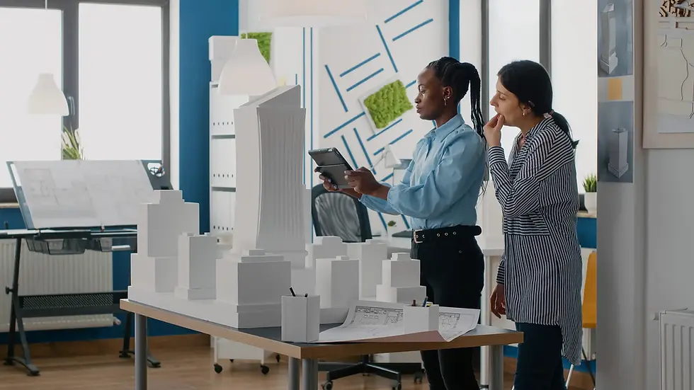 Architects reviewing a white 3D architectural model.