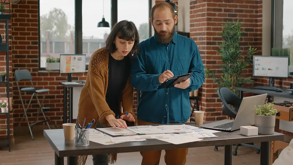 Two colleagues collaborating on a project in a modern office.