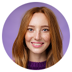 Smiling woman with long red hair against a purple background.