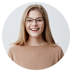 Smiling woman with glasses in a circular frame