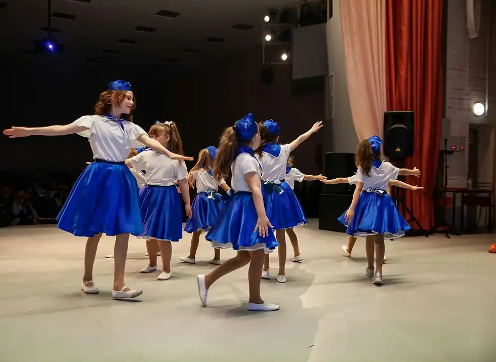Young dancers in blue skirts and white tops perform onstage, Events DansLab