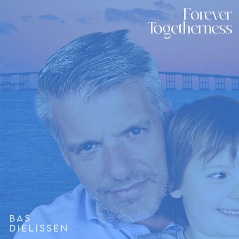 Father and son in front of water and bridge